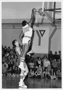 Suffolk University men's basketball player Donovan Little dunks the ball for two points during a game, circa 1978-1979
