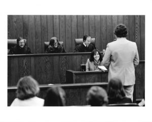 Suffolk University Professor and Associate Dean Marc G. Perlin (Law) seated on Moot Court judge's bench, circa 1980s