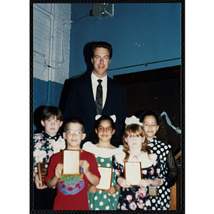 Former Boston Celtic Dave Cowens posing for a group picture with five boys and girls at a Kiwanis Awards Night