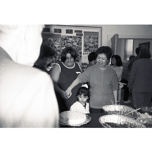 Suzanne Lee and others cut cake at an event