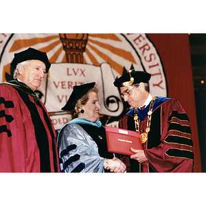 Madeleine Albright (center) receives honorary Doctor of Public Service degree from President Freeland (right)