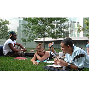 Torch Scholars relax on the grass during a scavenger hunt