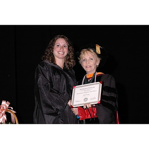 Dean Carole Kenner presents Julie Finkle with an Award for Academic Excellence at the School of Nursing convocation