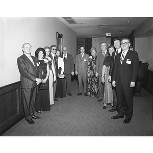 Twelve pose together at the Alumni Dinner Dance and reception