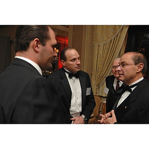President Joseph Aoun, far right, conversing with a group of guests at the Huntington Society Dinner