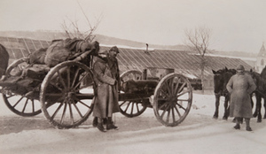 Soldiers and horse-drawn artillery on a snow-covered road