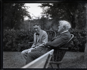 Group sitting on Windsor chairs on the lawn at the Fireside Inn: Harvey Firestone and Thomas A. Edison (l. to r.)