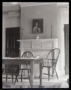 Dorothy Canfield Fisher: interior of home, showing table with Windsor charis, fireplace, and painted portrait of Fisher