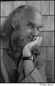 Ram Dass at typewriter: Portrait of Ram Dass smiling