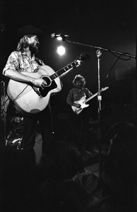 New Riders of the Purple Sage opening for the Grateful Dead at Sargent Gym, Boston University: John 'Marmaduke' Dawson playing acoustic guitar and signing, Dave Nelson in the background