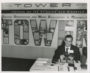 Jack Trapp at desk in front of ICD exhibit on the Tower System