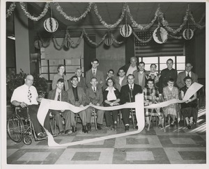 Group of men and women holding the signed scroll