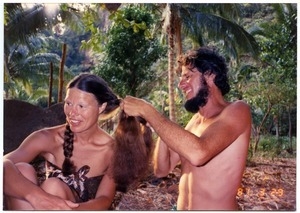 Mark Sommer braiding Sandi Sommer's hair on Phra Nang Beach in Thailand