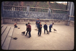 Children sweeping courtyard at Normal College