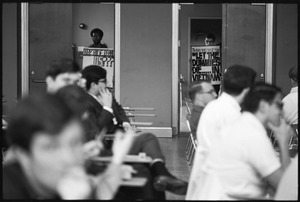 Protesters outside the Selective Service College Qualification examination to determine eligibility for an educational deferment from service in the Vietnam War: 'Taking the test says Let the dummies die.. in Vietnam'