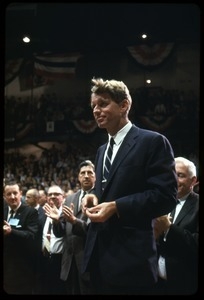 Robert F. Kennedy on the campaign trail, walking into a packed auditorium while stumping for Democratic candidates in the northern Midwest