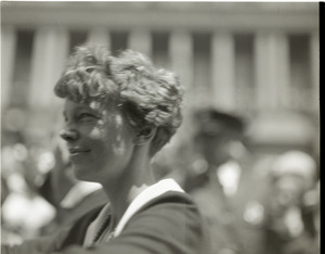 Amelia Earhart reception: close-up of Earhart riding in a car in front of the Massachusetts State House