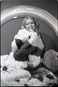 Lynn Smith wrapped in faux fur blanket, modeling Koss headphones