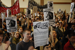 UMass student strike: strikers in the Student Union ballroom holding banner, signs, and cheering