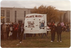 Protesters with a banner reading 'Adelante Mujeres: without the participation of women there is no revolution'