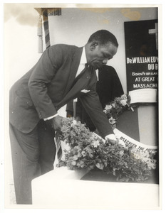Unidentified man lays a wreath at the graveside of W. E. B. Du Bois