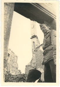 Sgt. Schwanzenberger (Co. H) in doorway of his old home in Wurzburg