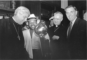 Mayor Raymond L. Flynn , Archbishop Bernard F. Law and others admiring the NBA championship trophy