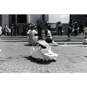 A woman dances in front of Boston's City Hall