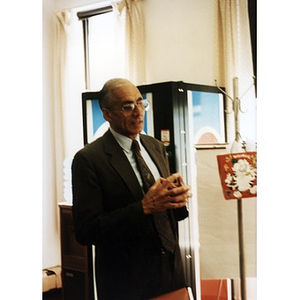 Unidentified man in a suit standing in the Inquilinos Boricuas en Acción offices.