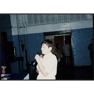 A girl speaking into a microphone at a Kiwanis Awards Night