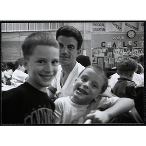 A man and two boys smile for the camera during a Kiwanis Awards Night