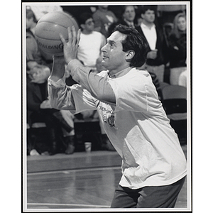 Former Boston sportscaster Mike Crispino shooting a basketball at a fund-raising event held by the Boys and Girls Clubs of Boston and Boston Celtics