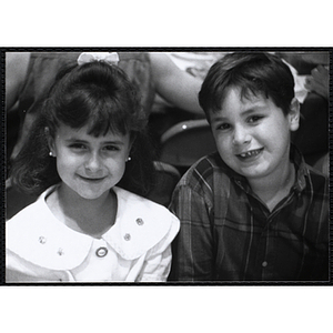 A girl and a boy smiling for the camera during a Boys & Girls Club event