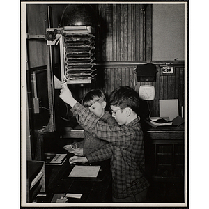 Two boys from the Boys' Clubs of Boston using an enlarger at a photographic laboratory