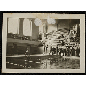 A swimmer sits poolside during a swim meet at the Harvard University natorium