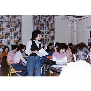 Teacher walks around the classroom during an English-language course