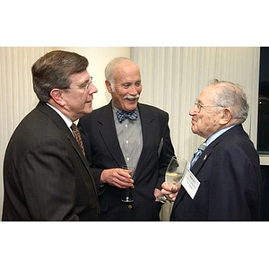 Three men converse at The National Council Dinner