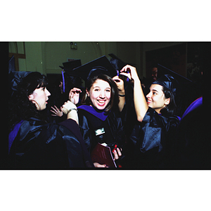 School of Law student getting her cap fixed by friend