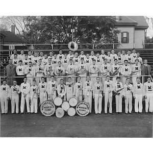 Group portrait of Northeastern marching band on football grandstand