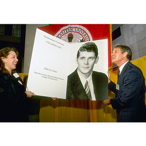 President John Curry, right, being presented with a large copy of his 1956 Cauldron yearbook photo