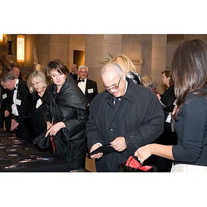 Guests look at photographs while leaving the Museum of Fine Arts