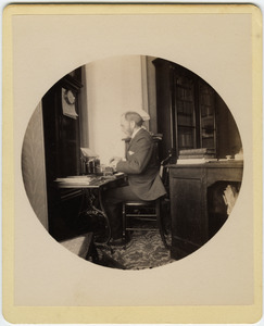 C.P. Blanchard typing at his desk
