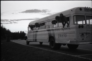 Free Spirit Press crew hanging out the windows of their bus (blurry)