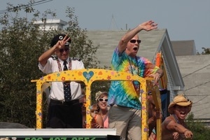 Paraders waving to the crowd from atop a float : Provincetown Carnival parade