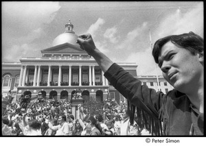 Kent State Shooting Demonstration at the Boston State House: protestors gathered on the State House steps and lawn, man raising fist in foregound