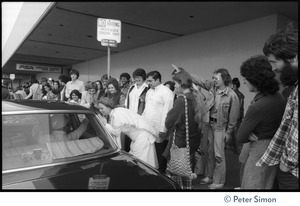 Devotees gathering around Swami Muktananda's car outside Los Angeles airport, seeing him off