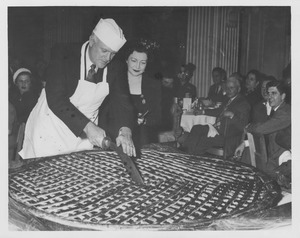 Ralph A. Van Meter cutting an enormous pie