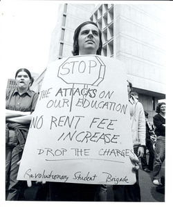 Board of Trustees fee increase demonstration: student holding sign