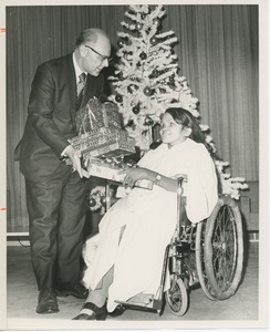 Dr. DiMichael with client in front of Christmas tree