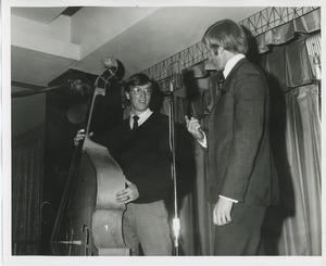 Actor Ken Howard talking to band member on stage at Thanksgiving celebration